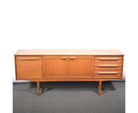 Vintage teak low-profile sideboard, by Stonehill Furniture Ltd, central cupboards flanked by a bank of three drawers and a fa