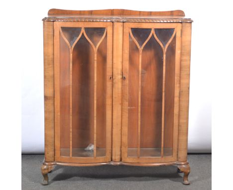 Art Deco walnut display cabinet, 1930s, serpentine front with glazed doors enclosing two glass shelves, cabriole legs, width 