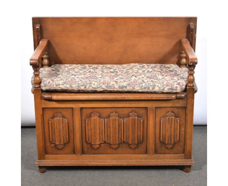 Light oak monk's bench, box seat, linenfold panelled front, loose cushion seat, width 99cm, depth 56cm, height 73cm.