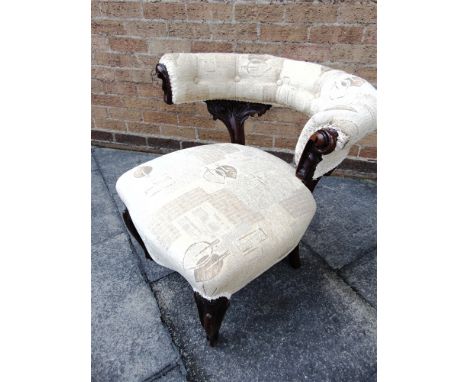 A VICTORIAN CARVED MAHOGANY FRAMED ARMCHAIR  with button upholstered horseshoe back on cabriole supports