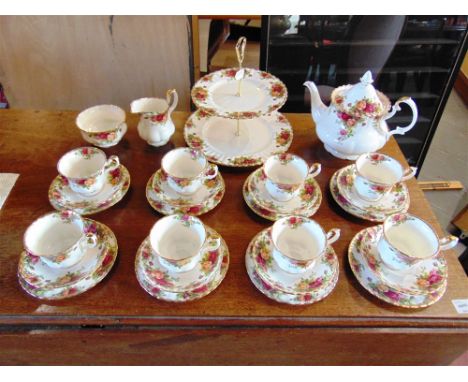 A ROYAL ALBERT 'OLD COUNTRY ROSES' TEA SERVICE  comprising teapot, sugar basin, milk jug and eight cups, saucers and side pla