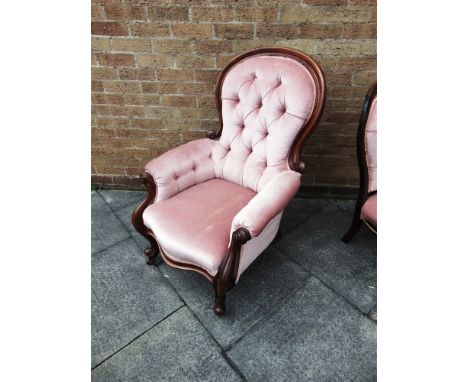 A VICTORIAN CARVED MAHOGANY ARMCHAIR  with button upholstered back and serpentine front seat on cabriole supports, 75cm wide