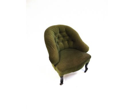 A BUTTON UPHOLSTERED TUB CHAIR  on ebonised supports with casters, 70cm wide