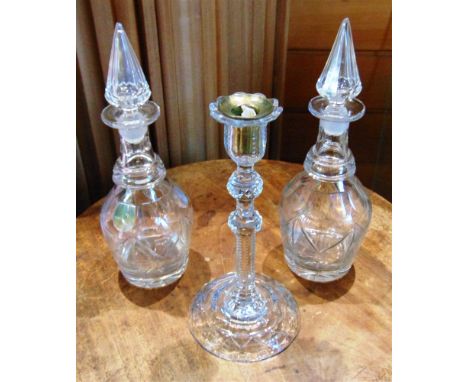 A PAIR OF GLASS DECANTERS AND STOPPERS  33cm high, together with a glass candlestick 27.5cm high