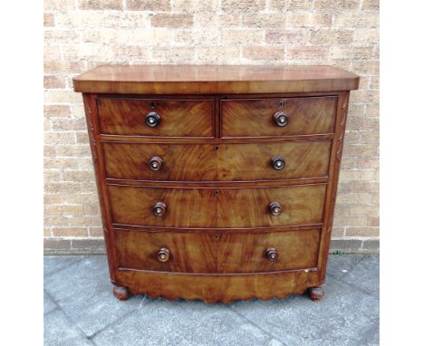 A MAHOGANY BOW FRONT CHEST OF TWO SHORT AND THREE LONG DRAWERS  on turned supports, 122cm wide 75cm deep 117cm high