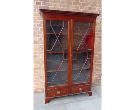 A TALL MAHOGANY BOOKCASE/DISPLAY CABINET with pair of astragal glazed doors enclosing three adjustable shelves and with two s