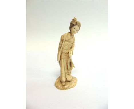 A JAPANESE MEIJI PERIOD CARVED IVORY FIGURE  of a Geisha holding flowers (damage/loss to one arm), signed to base, 13.5cm hig