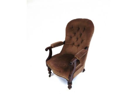 A VICTORIAN BUTTON UPHOLSTERED MAHOGANY FRAMED ARMCHAIR  on turned front supports with brass casters, 64cm wide 74 deep 97cm 