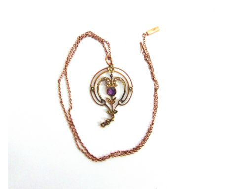 AN EDWARDIAN AMETHYST AND SEED PEARL PENDANT stamped 9 carat, 4cm long excluding the bale, on a chain, stamped '9ct' to the t