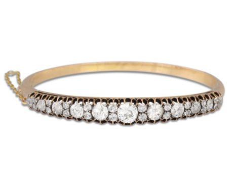 AN ANTIQUE DIAMOND BANGLE, the graduated old cut diamonds mounted in 15ct yellow gold. Estimated: weight of diamonds: 4.5 - 5