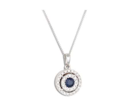 A DIAMOND AND SAPPHIRE TARGET PENDANT, mounted in white gold on a chain