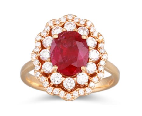 A RUBY AND DIAMOND CLUSTER RING, the oval ruby to two rowed diamond surround, mounted in 18ct yellow gold. Estimated: weight 