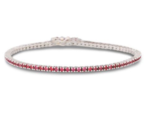 A RUBY LINE BRACELET, circular stones mounted in 18ct white gold. Estimated: weight of rubies: 2.45 ct.