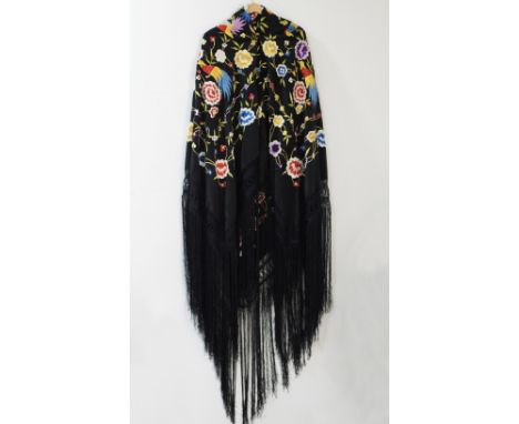 A large Spanish Manila Shawl (Manton de Manila) silk scarf, with fringe at the end and colourful embroideries on black backgr