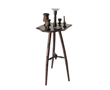 A c19th century smokers stand / table on three turned beech legs united by stretcher, the shaped top incorporating a tobacco 