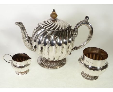 A LATE VICTORIAN SILVER SPHERICAL WRYTHEN FLUTED TEAPOT, Birmingham 1894, TOGETHER WITH AN ASSOCIATED AND SIMILAR CREAM JUG A