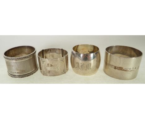 FOUR SILVER NAPKIN RINGS, VARIOUS, including a heavy engine turned example with ribbon pattern border, Sheffield 1905 and lat