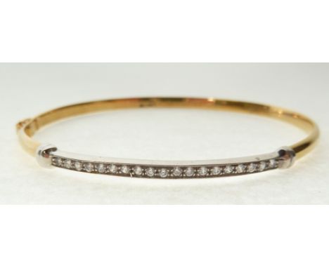 CUBIC ZIRCONIA SET 9CT GOLD HINGE OPENING BANGLE, the wide metal top claw set with 19 round brilliant cut CZ, Sheffield, 4g