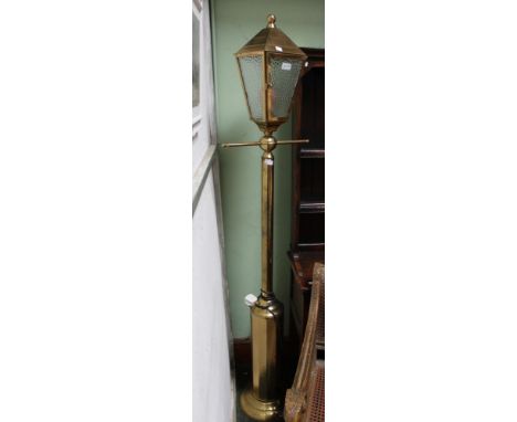 A brass indoor floor standing lantern