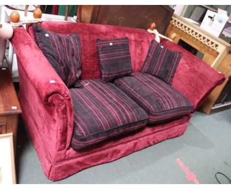 A red upholstered two-person sofa 