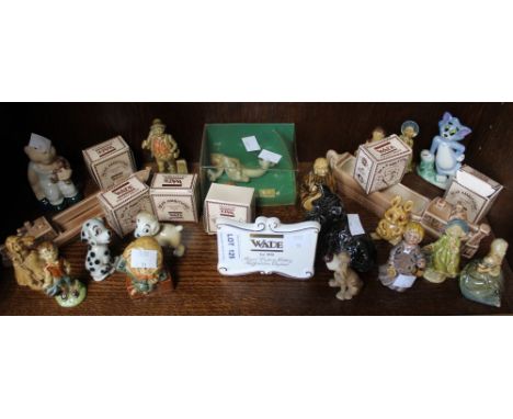 A shelf containing a good selection of Wade figurines etc
