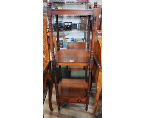 A mahogany three shelf wot-not with single shelf to based on brass castors