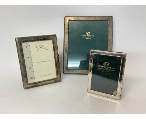 Three silver photo frames, the largest to fit a photograph 25cm x 20cmIn good overall condition with some minor wear - the tw
