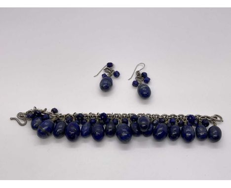 Silver and lapis lazuli bracelet and earrings, the silver chain links suspending egg-shaped lapis lazuli pendant drops, brace
