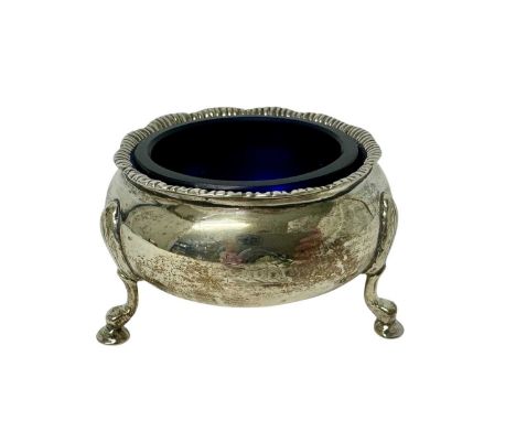 Victorian silver cauldron salt with gadrooned rim, engraved crest and three scroll legs, with blue glass liner (London 1894) 