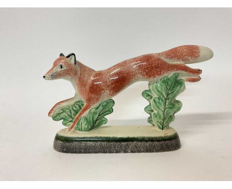 Rye Pottery model of a running fox, dated 2004 to base, 17cm high x 27cm long