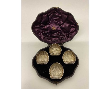 Cased set of four silver salts, of scallop shell form, each supported by mythical dolphins, Birmingham 1865 (Henry Atkin), in