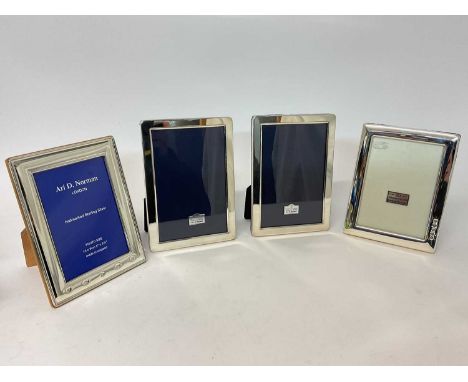Four silver photo frames, including two to hold 5" x 3 1/2" photos, and two to hold approx 5 3/4" x 3 3/4" (probably meant fo