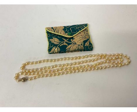Long string of cultured pearls with silver gilt clasp, 105cm long