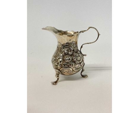 










18th century embossed silver milk jug, on three pad feet, scroll handle, 9cm high










