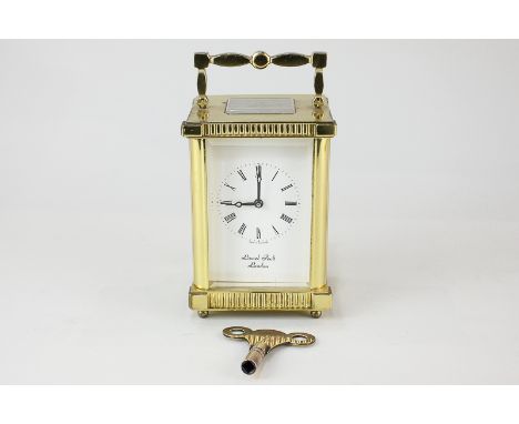 A gilt brass cased carriage clock, the dial and movement marked Lionel Peck, London, with Roman numerals and key wind movemen