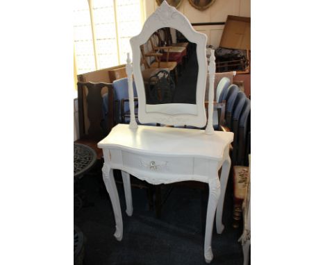 A modern white painted dressing table with foliate carved decoration and adjustable mirror, on cabriole legs, 80.5cm