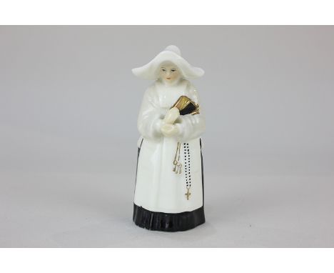 A Royal Worcester porcelain candle snuffer modelled as a nun, 9.5cm high