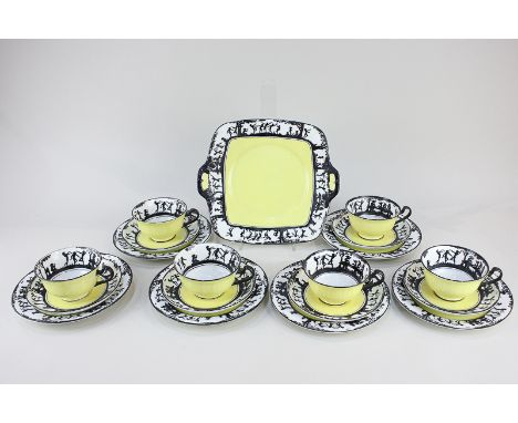 A Grimwade part tea service of six cups, saucers, side plates and sandwich plate, with yellow centres and borders of silhouet