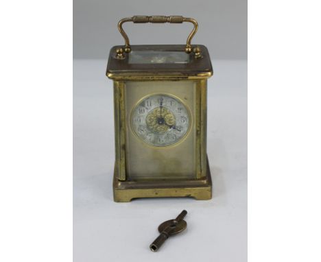A gilt brass and bevelled glass cased carriage clock, the circular silvered dial with gilt surround (a/f), 14cm high