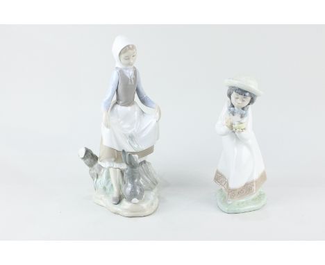 A Lladro porcelain figure of a girl and a rabbit, 23cm, and a Nao figure of a girl with a bird's nest, 18cm