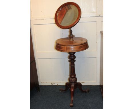 A 19th century mahogany shaving stand with adjustable mirror, on circular box base with two compartments, carved baluster sup