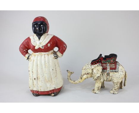 A painted cast iron elephant toy with lifting tail and trunk, together with a painted cast iron money box modelled as a large