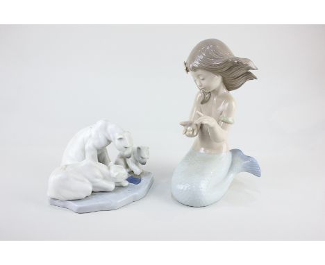 A Nao porcelain model of a mermaid holding a pearl, 21cm, and a Lladro group of three polar bears, 16cm