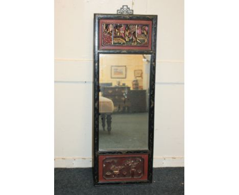 A Chinese lacquered and carved rectangular giltwood wall mirror with two panels depicting interior scenes, central mirror pan