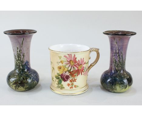 A pair of Arts and Crafts pottery bud vases with floral design on lilac ground, together with a Royal Worcester porcelain mug