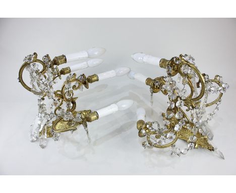 A pair of gilt brass four-branch candelabra wall lights hung with cut glass droplets, 35cm high, (a/f) must be tested by elec