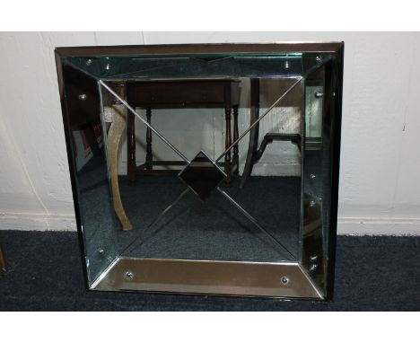 A modern panelled wall mirror, square shape with mirrored frame, diagonal panels and coloured glass diamond centre, 58cm