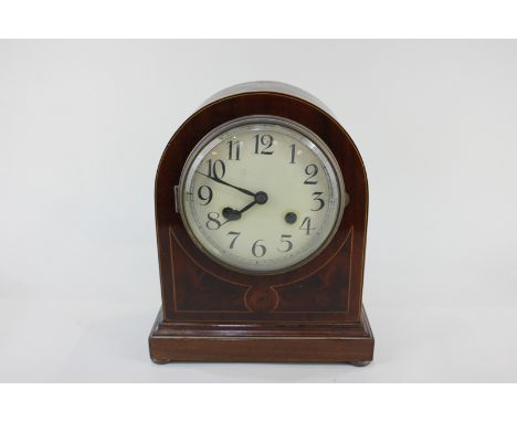 An inlaid mahogany mantel clock, 14cm circular dial with Arabic numerals, mechanism striking on a gong, in dome case on butto