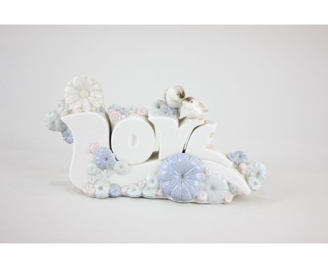 A Nao porcelain ornament of the word 'Love', mounted with two birds and flowers, 21cm