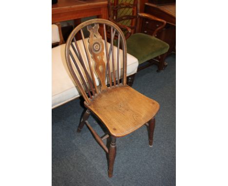 A Windsor chair with wheel and stick back and elm seat, on turned legs